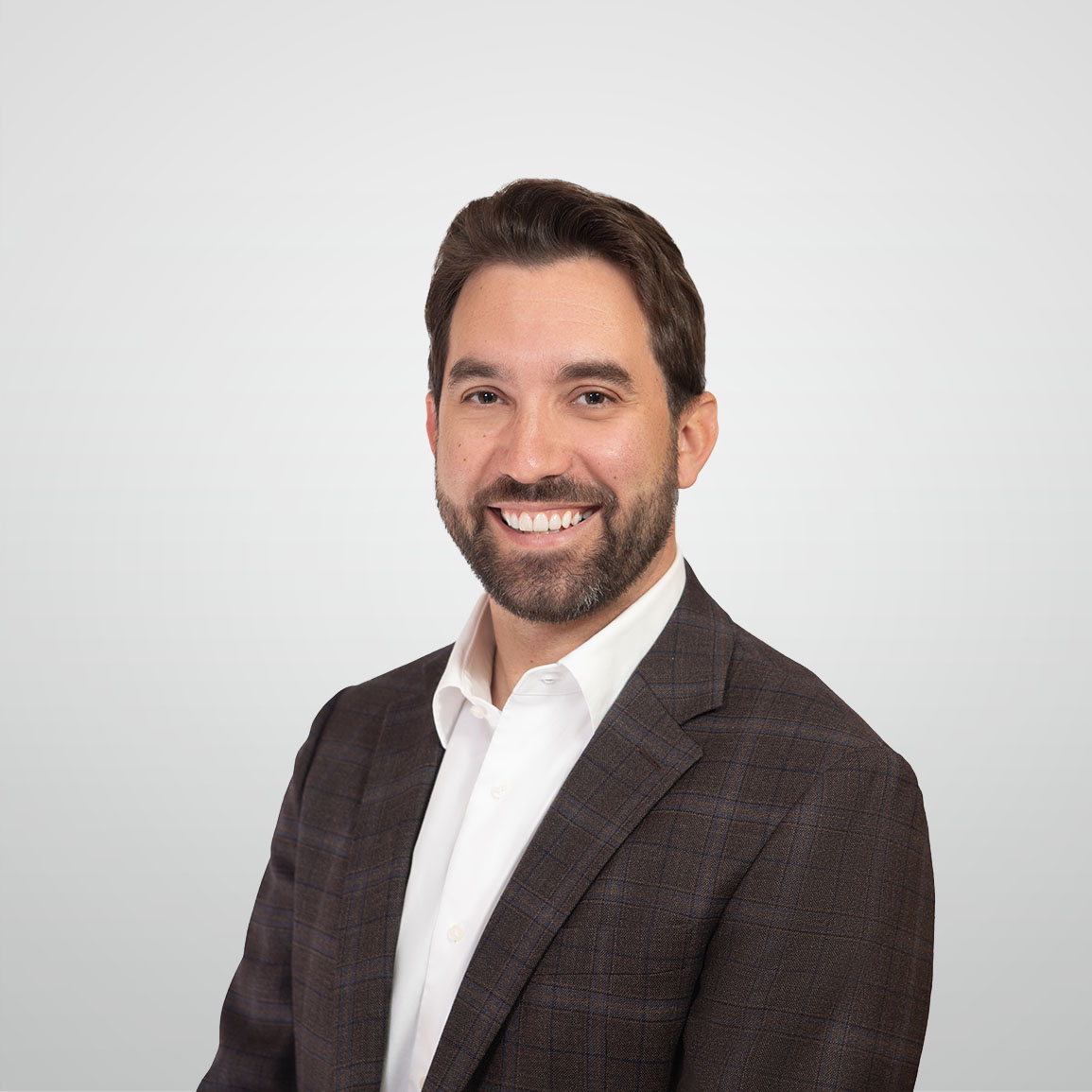 Professional headshot of Travis Higgins, Investment Counselor in ATBIM